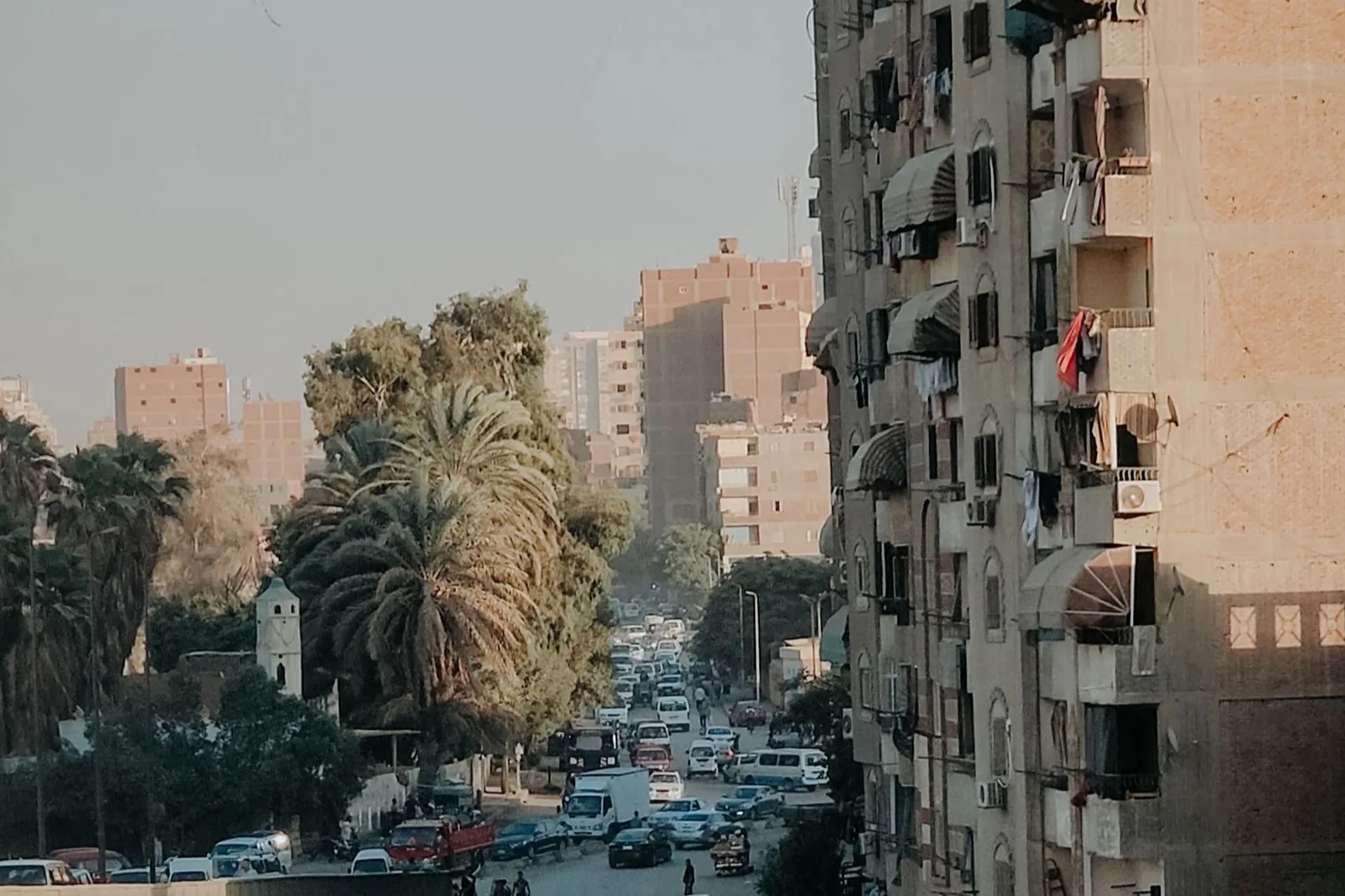 Layered balconies and textured facades on a Cairo street