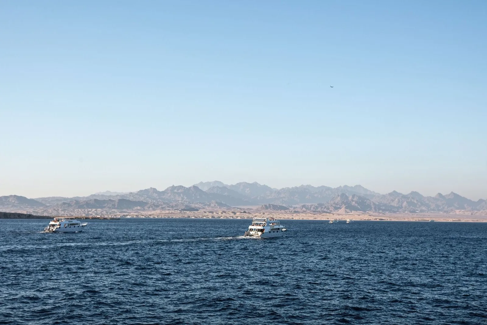 Clear blue water meeting a dry Egyptian coastline